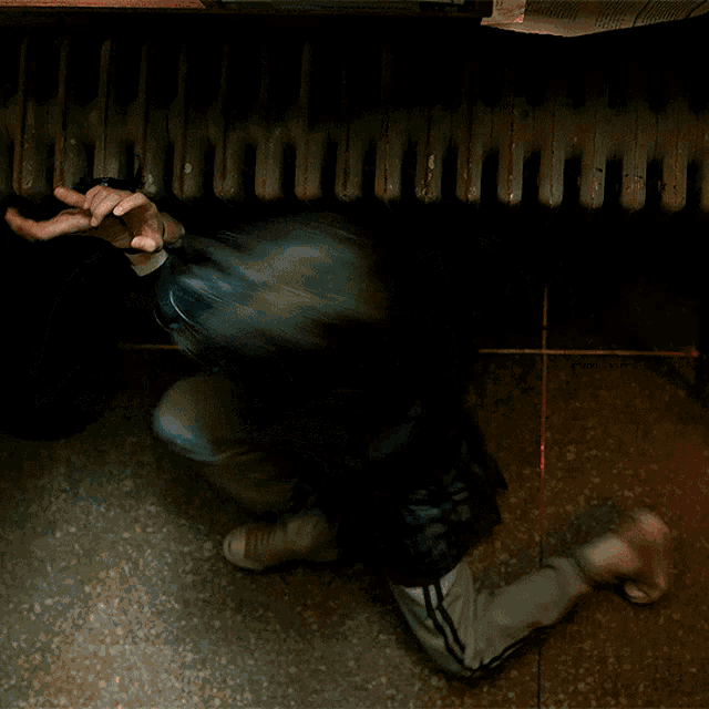 a woman is taped to the floor with duct tape on her mouth