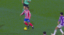 a soccer goalie in a purple jersey is diving to block a shot