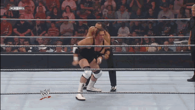 two wrestlers in a wrestling ring with the words wwe hd on the bottom right