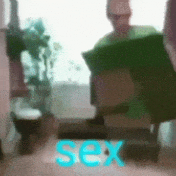 a blurry picture of a man sitting on a chair with the word sex in blue letters .