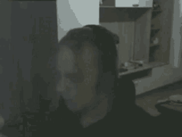a man wearing headphones is blowing his nose with a tissue