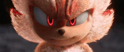 a close up of a stuffed animal with red eyes that looks like shadow the hedgehog