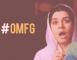 a woman with a surprised look on her face is standing in front of a #omfg sign