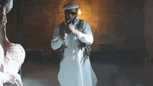 a man smoking a cigarette in a dark room