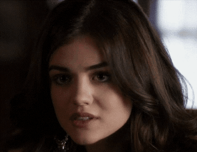 a close up of a woman 's face with brown hair
