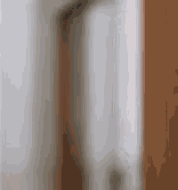 a blurred image of a door with a white wall behind it