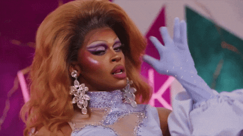 a drag queen wearing a blue dress and gloves
