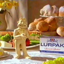 a box of lurpak butter sits next to a figurine of a man