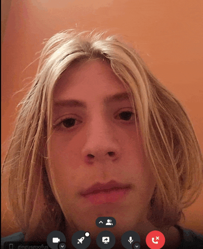 a man with long blonde hair is on a video call