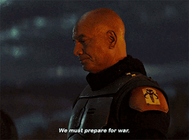 a man in a military uniform is saying we must prepare for war