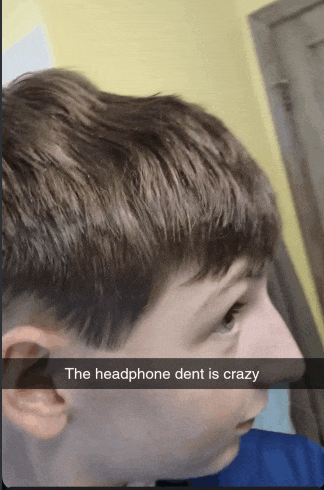 a boy with a headphone dent is crazy on his face