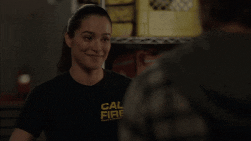 a woman wearing a black shirt that says cal fire on it