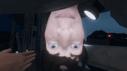 a man 's face is upside down with a flashlight shining on his head