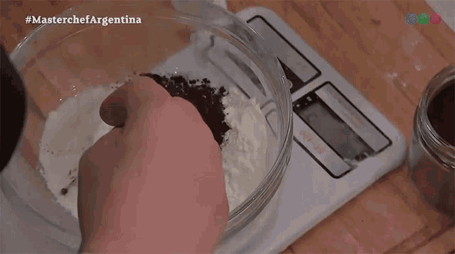 a person is measuring ingredients on a scale with the hashtag #masterchefargentina