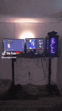 a computer desk with two monitors and a computer case with a tiktok logo