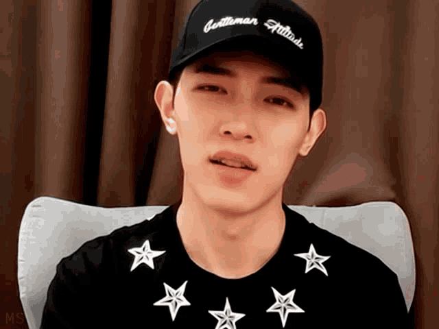a man wearing a black hat that says gentleman attitude on it
