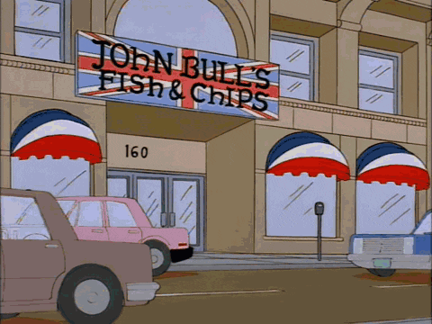a sign for john bull 's fish & chips hangs above the entrance