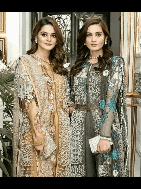 two women are standing next to each other wearing dresses