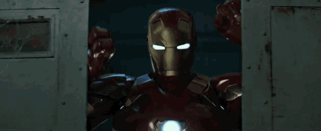 a man in a red and gold iron man suit is standing in a doorway