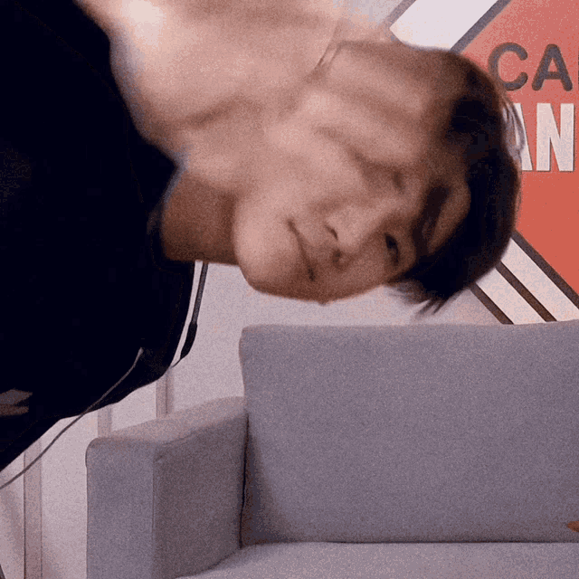 a man is laying on his back in front of a sign that says ca on it