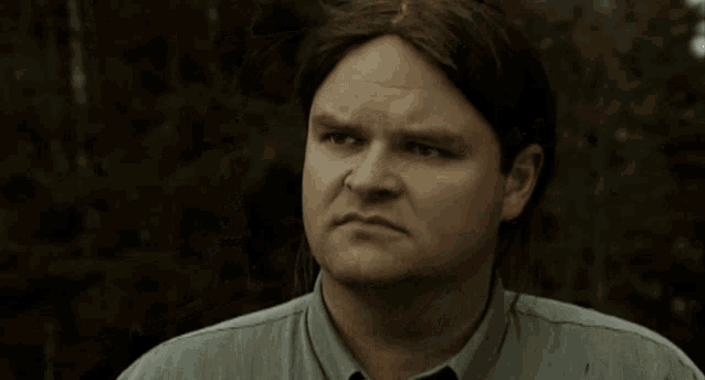 a man says okay in front of trees