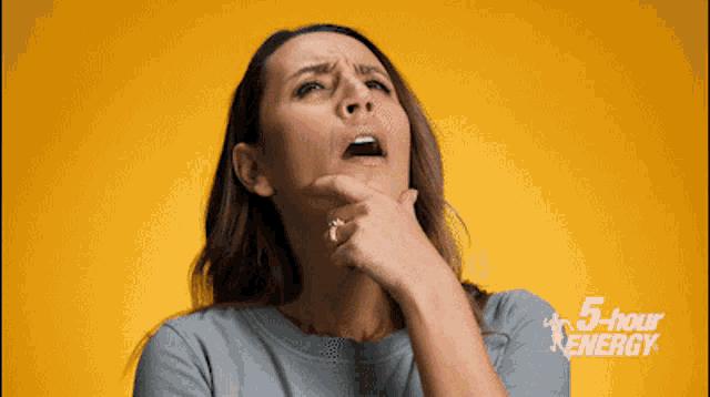 a woman 's face is against a yellow background with the words 5 hour energy on it