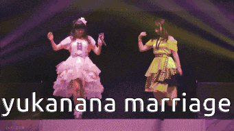 two girls holding hands on a stage with the words yukanana marriage written on the bottom