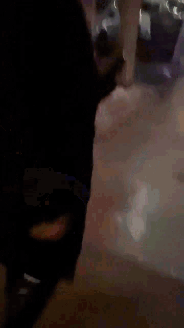 a blurry picture of a person walking down a street at night