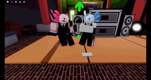 two axolotls are standing on a stage in front of speakers and the word tiamat is on the screen