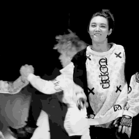 a black and white photo of a woman wearing a sweater that says ' x ' on it