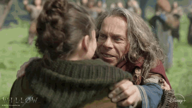 a man and a woman hugging with the word willow on the bottom right