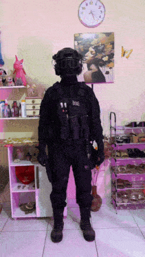 a man in a military uniform is standing in front of a clock that shows the time as 10:13