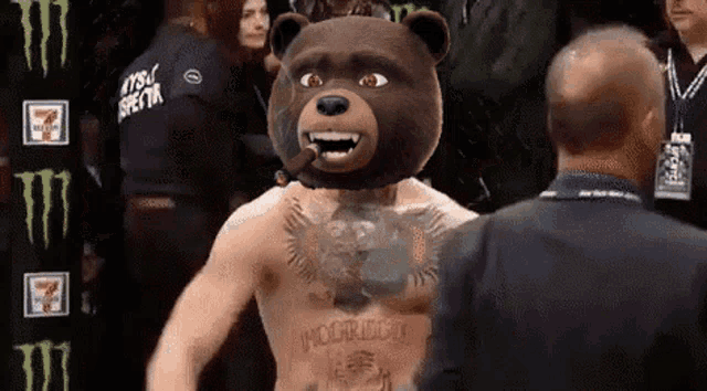 a man wearing a teddy bear mask is talking to a man in a suit