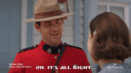 a man in a red uniform is talking to a woman in a hallmark movie
