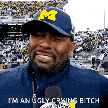 a man wearing a hat with the letter m on it says i 'm an ugly crying bitch .
