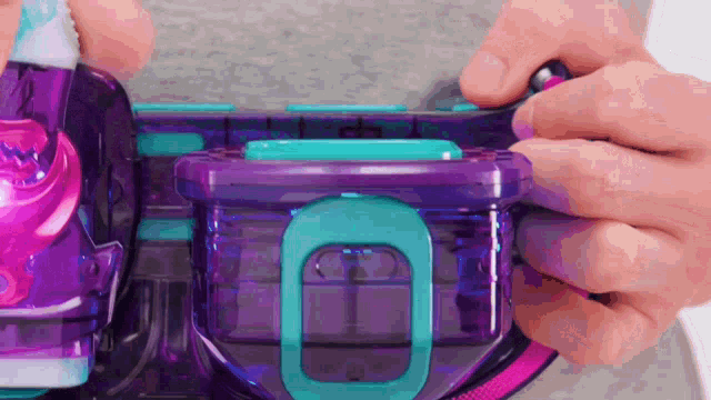 a person is holding a purple and blue container with a blue handle