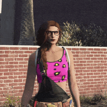 a woman wearing glasses and a pink sports bra stands in front of a brick wall
