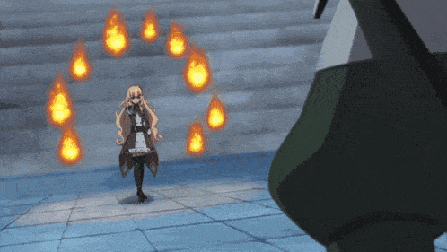 a girl in a dress stands in front of a wall of fire