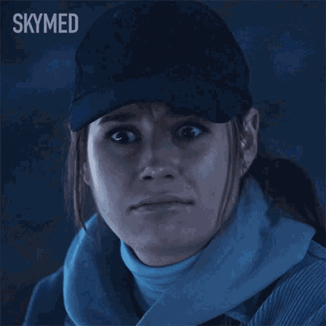 a woman wearing a hat and scarf says messy in a skymed ad