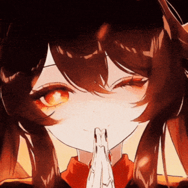 a close up of a girl 's face with her hands together