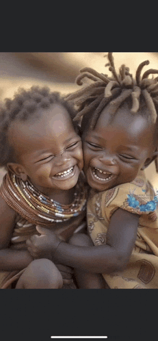 two little girls are laughing together and hugging each other