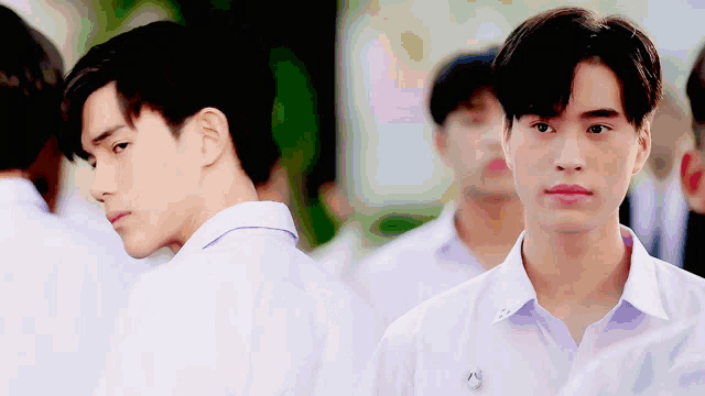 a man in a white shirt with a badge on his chest