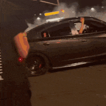 a blurry picture of a car driving down a road at night