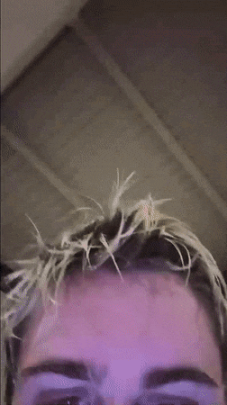 a close up of a man 's face with blonde hair