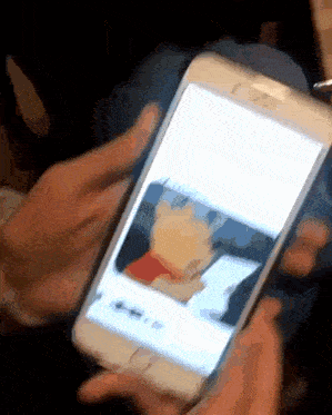 a person is holding a cell phone with a picture of winnie the pooh on it