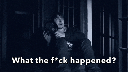 a man is sitting in a dark room with the words what the f * ck happened