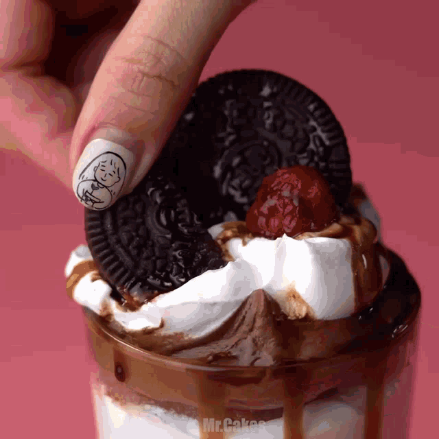 a close up of a person 's hand holding an oreo cookie
