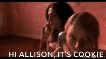 two women are talking on a telephone and one of them is saying hi allison , it 's cookie .