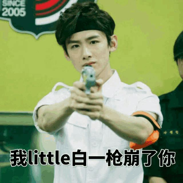 a man is pointing a gun with a sign that says since 2005
