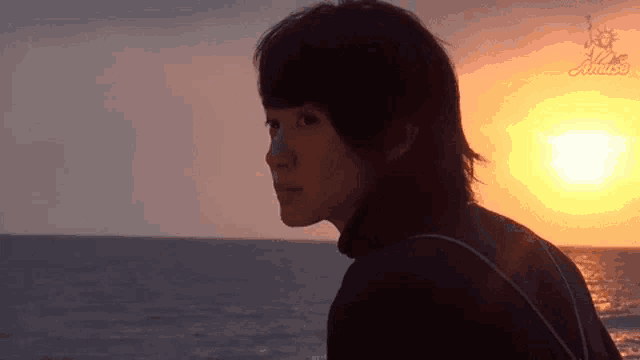 a person standing in front of a sunset with the word cruise on the bottom right corner